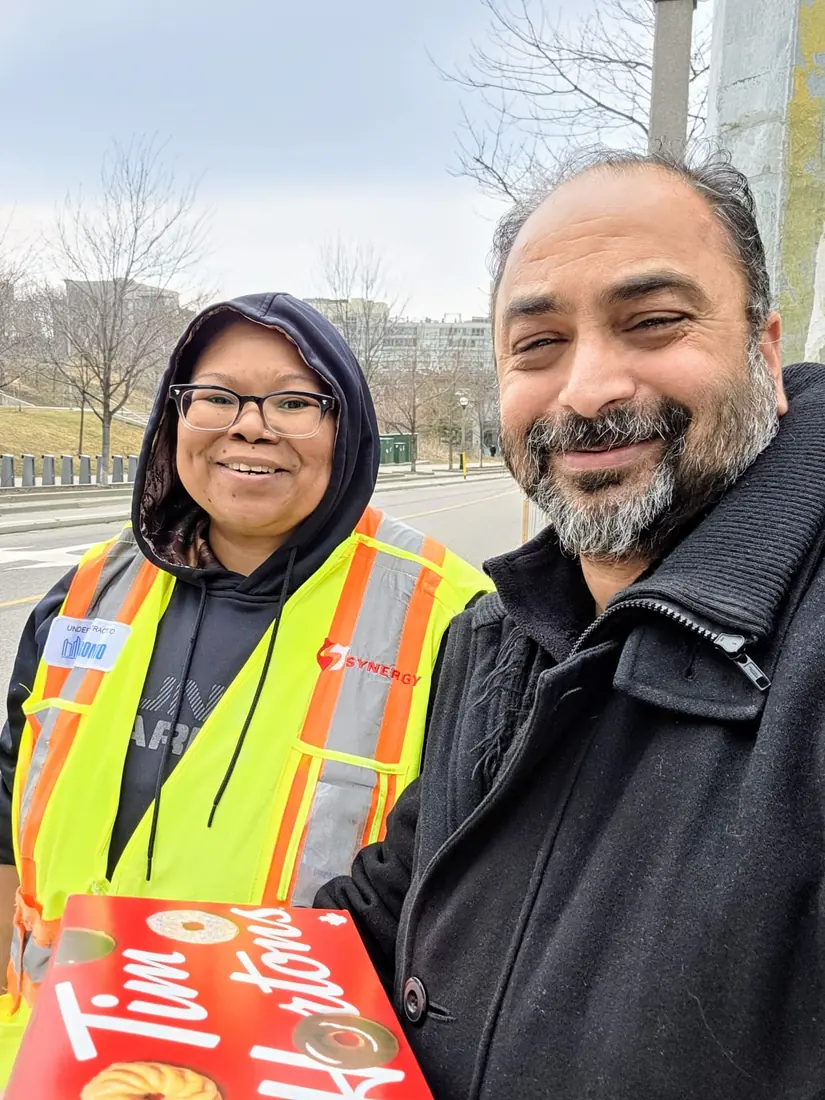 Husain with a community volunteer