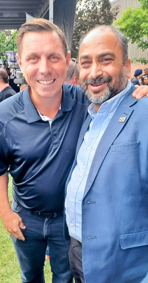 Husain with a community leader outdoors