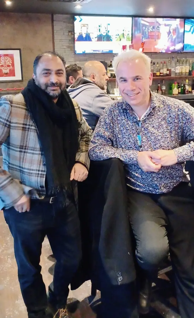 Husain with a friend at a local bar