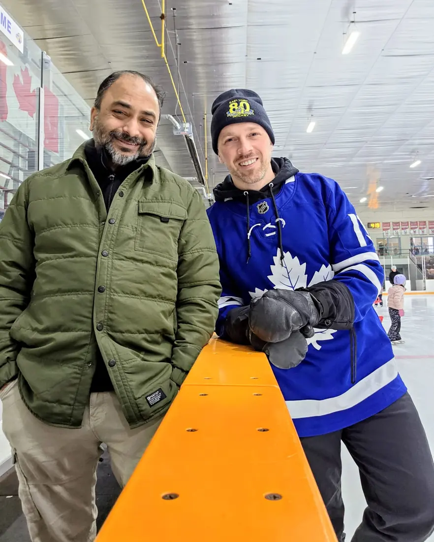 Husain at a hockey rink with a Toronto Maple Leafs fan