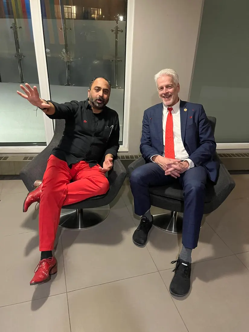 Husain in conversation with a colleague